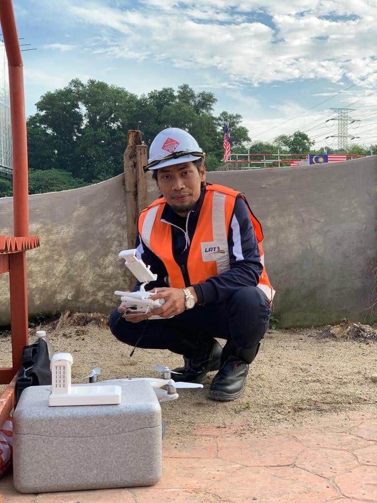 Wan Muhammad Fairuz operating a drone at an LRT3 project site